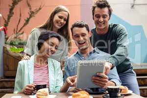 Happy friends using tablet