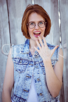 shocked hipster woman smiling at the camera