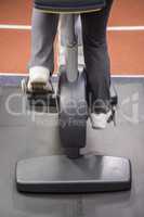 Lower section of woman on exercise bike