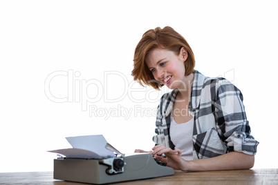 smiling hipster woman typing on her typewriter