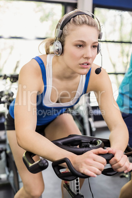 Fit group of people using exercise bike together