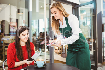 Smiling waitress taking an order