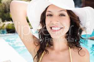 Beautiful woman smiling near poolside