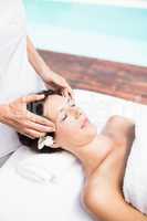 Woman receiving a head massage from masseur