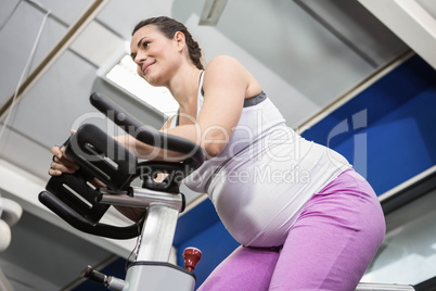 Pregnant woman using exercise bike