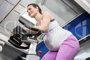 Pregnant woman using exercise bike