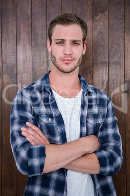 Handsome hipster smiling with arms crossed