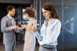 Businesswoman using mobile phone in office