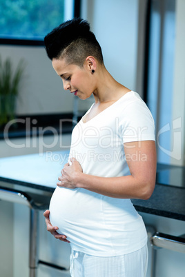 Pregnant woman touching her belly