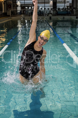 Smiling woman in swimsuit jumping