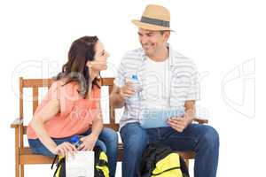 Couple on bench using tablet