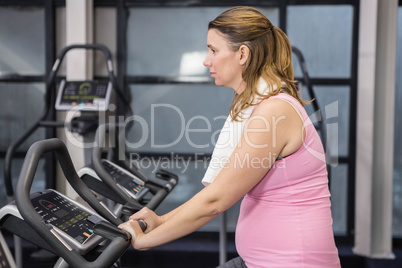 Pregnant woman on exercising bike