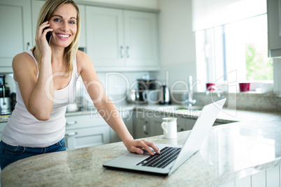 Pretty blonde woman looking at laptop