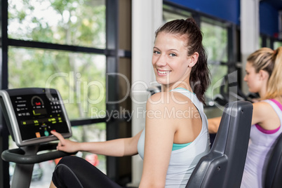 Fit woman doing exercise bike