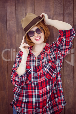 smiling hipster wearing a trilby and sunglasses