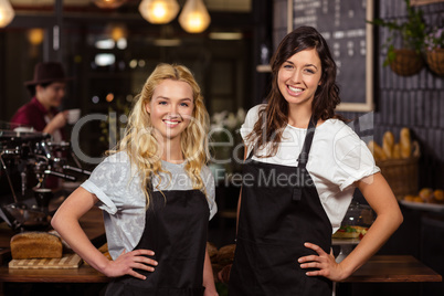 Pretty waitresses posing in front of the counter