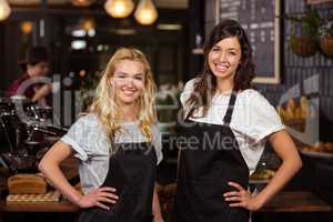 Pretty waitresses posing in front of the counter