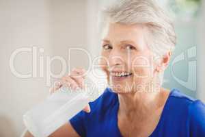 Happy senior woman drinking water