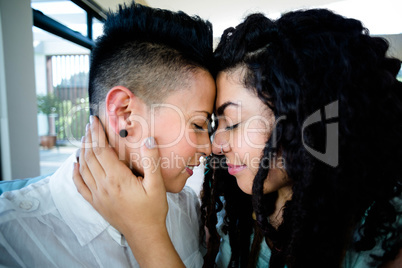 Lesbian couple embracing each other and smiling