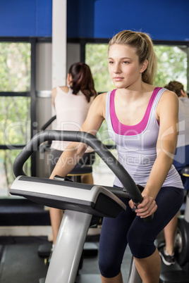 Fit woman doing exercise bike