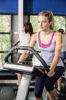 Fit woman doing exercise bike