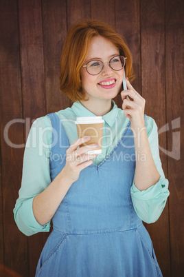 Hipster talking on phone having coffee