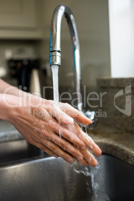 Pretty woman washing her hands