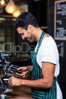 Smiling waiter making cup of coffee