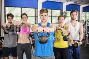 Fitness class lifting dumbbells