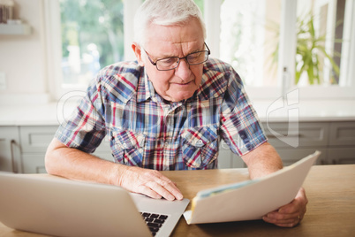 Worried senior man looking at a document