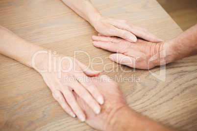 Senior couple holding hands