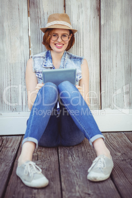 smiling hipster woman holding a tablet