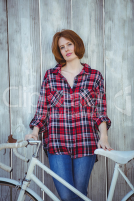 beautiful hipster woman standing with a bicycle