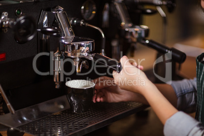 Close up of barista using coffee machine