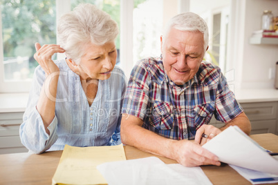 Senior couple checking their bills