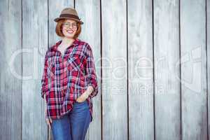 smiling hipster woman with her hand in her pocket