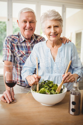 Senior couple preparing salad