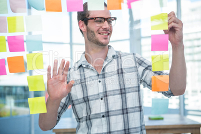 Hipster man looking at post-it