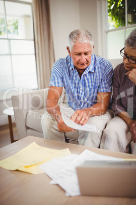 Senior man showing documents to woman