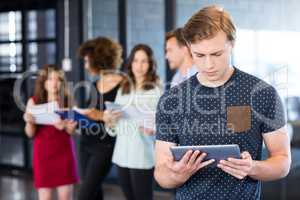 Man looking at digital tablet in office
