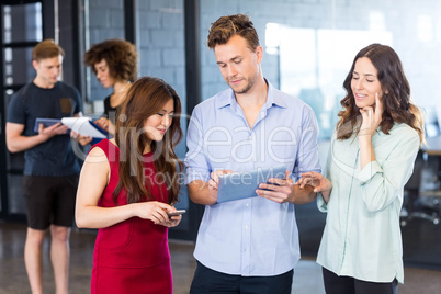 Colleagues looking at digital tablet and having a discussion