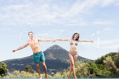 Young couple enjoying near pool