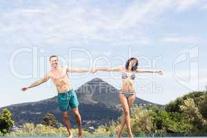 Young couple enjoying near pool