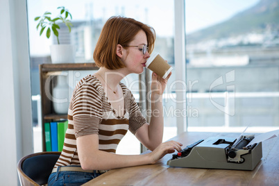 hipster business woman drinking a cup of coffee