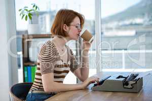 hipster business woman drinking a cup of coffee