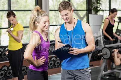 Trainer man talking with sportswoman