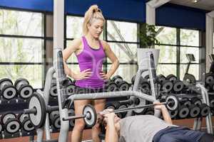 Trainer woman helping athletic man