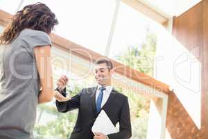 Real-estate agent giving keys