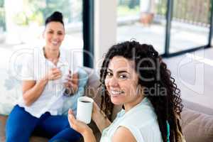 Lesbian couple having a cup of coffee
