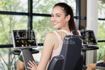 Fit woman doing exercise bike